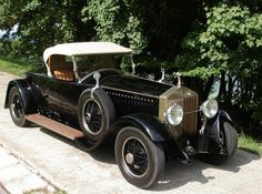 an antique car parked on the side of the road