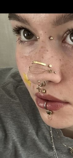 a woman with piercings on her nose looking at the camera