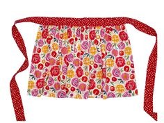 a red and white flowered apron with polka dots on the bottom, tied to it's side