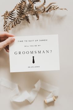 someone holding up a card that says, time to suit up james will you be my groomsman?