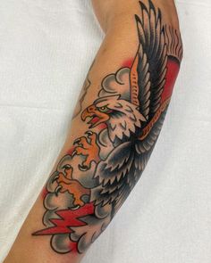 an eagle and lightning tattoo on the arm