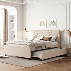 a large bed sitting on top of a hard wood floor next to a white wall