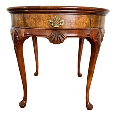 an antique wooden table with drawers on one side and a drawer on the other end