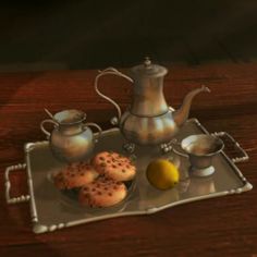 there is a tray with pastries on it and a tea pot next to it