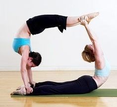 two people are doing yoga poses on the floor