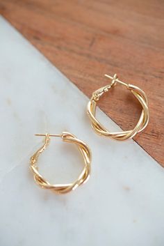 Our Dainty Twisted Hoop Earrings are a perfect, minimalist earrings to add to any outfit! Made with 14K Gold filled metal, and measure 27mm x 28mm. Available in gold. Lead and Nickle free.#DaintyGoldHoopTwistedEarrings#GoldFilledTwistedHoopEarrings#Earrings #MinimalisticEarrings#BeachVibeEarrings #EarringInsporationIdeas #SummerEarrings#StylishGoldEarrings #PrettyEarrings#CuteGoldEarrings #AdorableEarrings#CuteJewelryIdeas #SimpleEarrings#Earrings #GoldHoops #EarringIdeas #CuteSummerJewlery Dainty Jewelry Earrings, Gold Hoop Earrings Outfit Casual, Quince Earrings, Minimal Gold Earrings, Gold Hoop Earrings Outfit, Trendy Gold Earrings, Cute Gold Earrings, School Earrings, Minimal Gold Jewelry