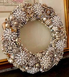 a close up of a wreath made out of pearls and other beads on a table