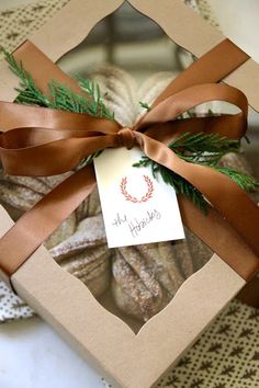 a box filled with cookies wrapped in brown ribbon