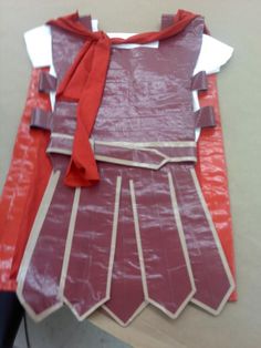 the costume is made out of paper and red ribbon