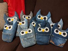 four denim owls sitting on top of each other in the shape of jeans with eyes painted on them