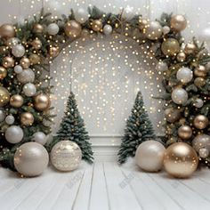 two christmas trees and ornaments in front of a white wall with snowflakes on it