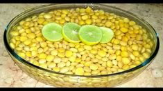 a bowl filled with beans and lime slices