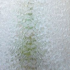 a frosted glass window with small white flowers on it