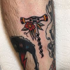 a close up of a person's leg with a tattoo on it and an animal