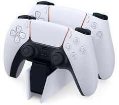 three white video game controllers sitting on top of each other