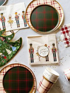 the table is set with christmas themed plates and napkins