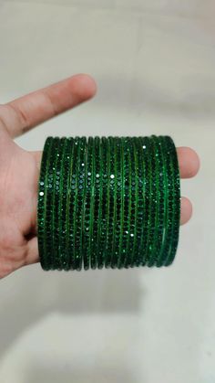 Bangles Name - Penali Burj Khalifa   Color - dark green   Size - 2.2/2.4/2.6/2.8   Weight - 60 grams   Piece - 12   Stone Color- green  100% Glass Bangles & Handmade Product. You can wear it while going to a wedding by matching it with your clothes. You can also gift it to someone. You can also wear it in an engagement. It looks very beautiful in your hands. about shipping  Ships within 1 to 3 business days after payment is received  We ship orders every day except Sundays and holidays  When you Bangles Glass Beautiful, Green Round Bracelets For Party, Adjustable Green Bangle For Party, Adjustable Green Round Bangle, Adjustable Green Bangle, Green Emerald Bracelets For Party, Adjustable Green Emerald Bracelet, Green Bangles, Glass Bracelets