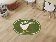 a green door mat with a white duck on it in a child's room