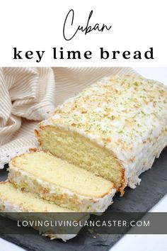 a loaf of cake with white frosting and sprinkles cut into slices