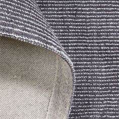 close up view of the side of a gray and white sweater