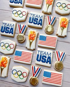 cookies decorated with olympic symbols and medals on a white table top for the team usa olympics