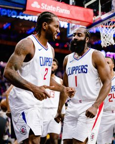 two basketball players standing next to each other