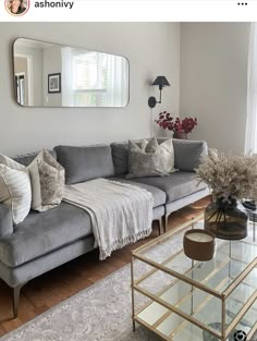 a living room filled with furniture and a large mirror