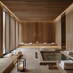 an indoor spa with large windows and wooden slatted walls