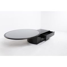 a black table with a glass top and drawers