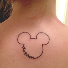 the back of a woman's neck with a mickey mouse tattoo on it