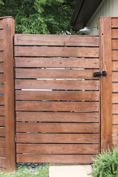 a wooden fence is next to a house