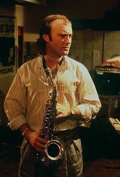 a man holding a saxophone in his hands