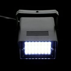 a light that is on top of a black surface with some lights in the dark