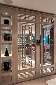 an ornate glass door in the middle of a room with bookshelves and vases