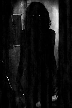 black and white photograph of a woman in the dark