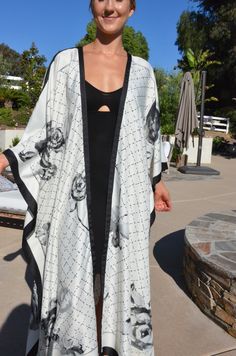 Enjoy summer in this beautiful silk white and black kimono. Dressy or casual . Not a sheer fabric. Medium weight silk. One size. The width is 52 inches when closed. The length is 50 inches. Silk Beachwear Kimono With Kimono Sleeves, Silk Kimono With Kimono Sleeves For Beach Cover-up, Summer Silk Kimono With Open Front, Silk Open Front Kimono For Summer, White Silk Kimono For Summer, Summer White Silk Kimono, Chic Long Printed Kimono, Elegant Summer Kimono With Open Front, White Bohemian Silk Kimono