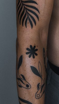 a man's arm with tattoos on it