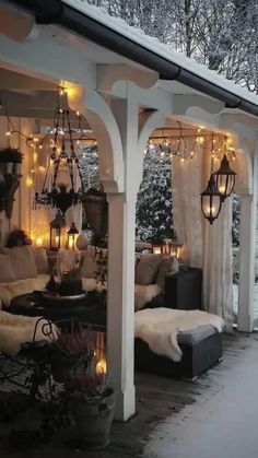 an outdoor covered porch with lights and furniture