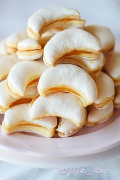 a pink plate topped with cookies covered in white icing