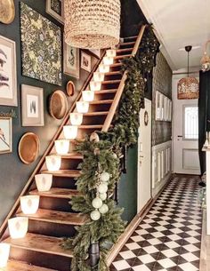 a staircase decorated with christmas garland and lights