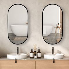 there are two mirrors on the wall above the sinks