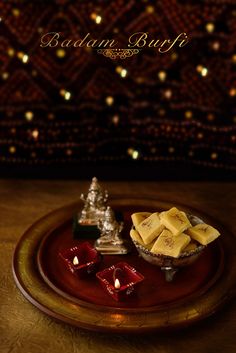 there is a plate with some food on it and candles in front of the plate