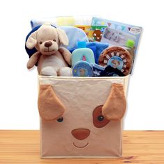 a stuffed dog is in a toy storage bag on a wooden table next to a baby's diaper