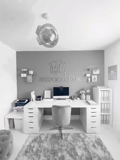 a white desk sitting in the middle of a room next to a chair and rug