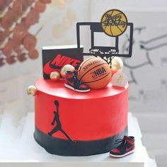 a red cake with basketballs and shoes on it