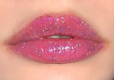 Shade (#4) "Venus Frost" is a tinted purple lip gloss with holographic sparkles that is moisturizing and made with only vegan ingredients.   Net WT.: 3.2g/0.11oz Ingredients: Polyisobutene, Paraffinum Liquidum, Octyldodecanol, Caprylic/Capric Triglyceride, Tridecyl Trimellitate, Hydrogenated Polyisobutene, Hydrogenated Styrene/Isoprene Copolymer, Silica Dimethyl Silylate, Calcium Aluminum Borosilicate, Synthetic Fluorphlogopite, Silica, Mica, Tin Oxide Pigment Metal 1 (CI 77000), Titanium Dioxide(CI 77981), Iron Oxide Black(CI 77499), Iron Oxide Red (CI 77491), Silver(CI 77820) D&C Red 27 Allake (CI 45410), FD&C Yellow No.6 (CI 15985), FD&C Red No.40 (CI 16035), D&C Red No.6 (CI 15850). Pigment Blue 27 (CI 77510), FD&C Blue 1AL Lake (CI 42090)  Color may vary depending on your monitor sett Pink Glitter Lipstick, Purple Lip Gloss, Alien Makeup, Purple Holographic, Glitter Lip, Glitter Lipstick, Glitter Lip Gloss, Vegan Ingredients, Purple Lips