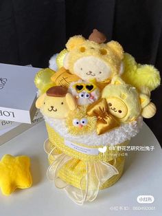 a yellow teddy bear sitting in a basket with other stuffed animals on top of it