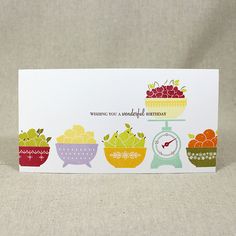 a birthday card with an image of fruit on a scale