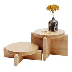 two wooden stools and a table with a vase on top, both made out of plywood