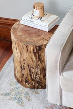 a wooden table sitting on top of a rug next to a couch